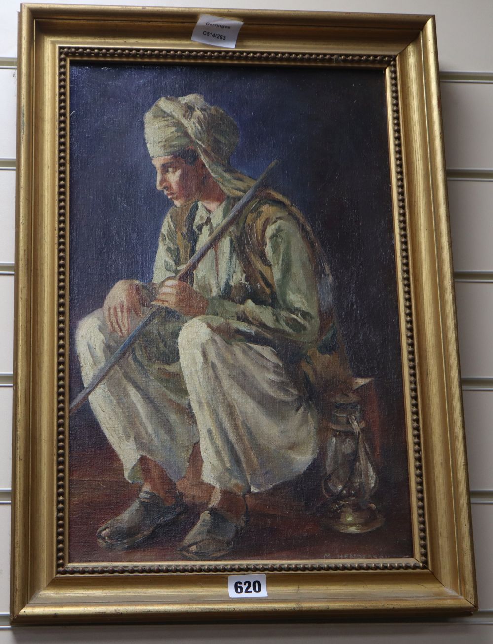 M. Hendersson, oil on canvas board, Sikh seated with a walking stick and lantern, signed, 44 x 29cm